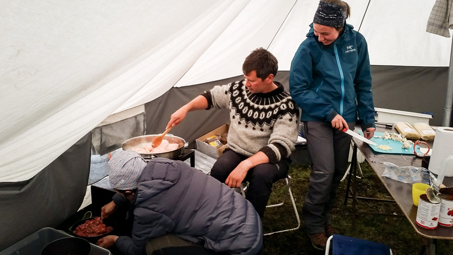 Maxime and 2 of my trekking companions preparing dinner inside the cook/dining tent