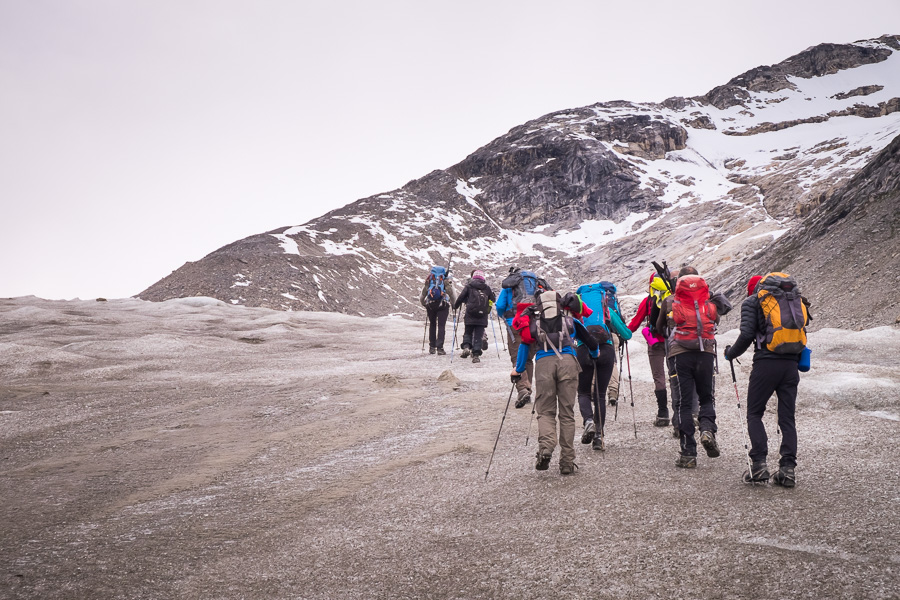 Trekking group hiking across another unnamed glacier on the way to the Karale glacier viewpoint