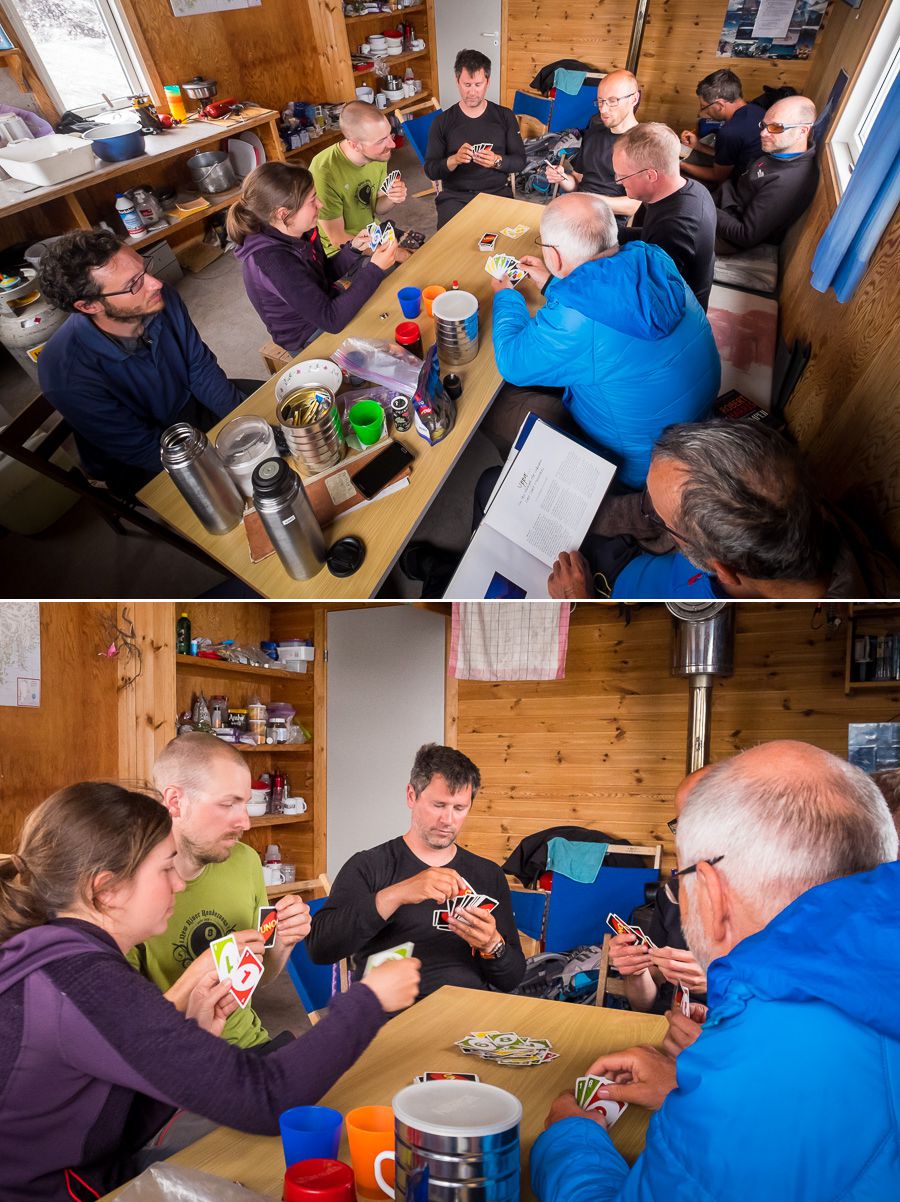 Several of the group playing UNO around the dining table at the Tasiilaq Mountain Hut