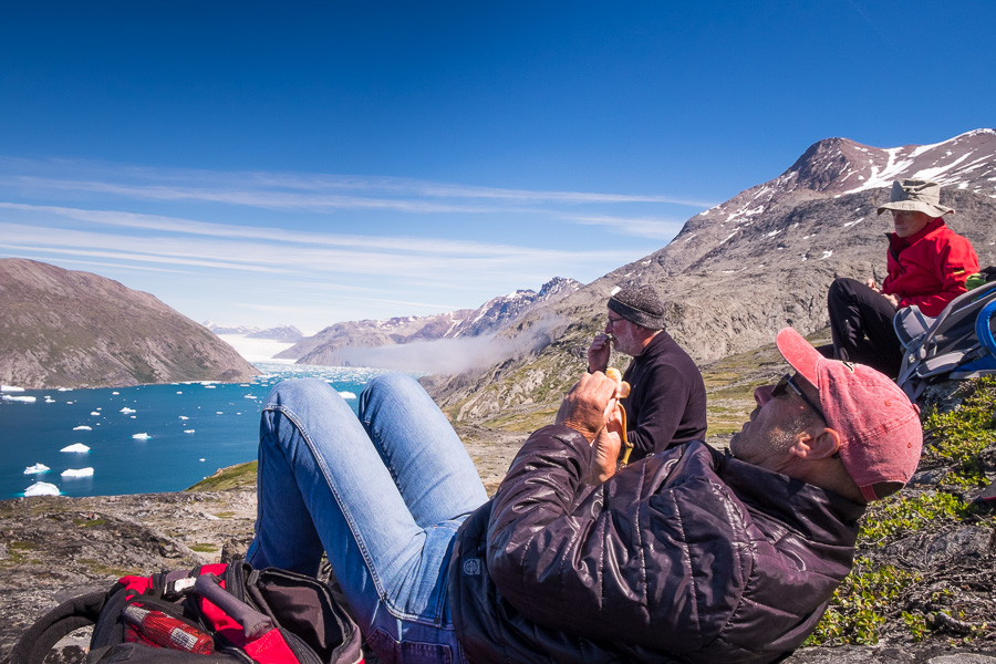Friends hanging out and admiring the Qooroq Glacier at the viewpoint of the Lake and Plateau Hike near Igaliku in South Greenland