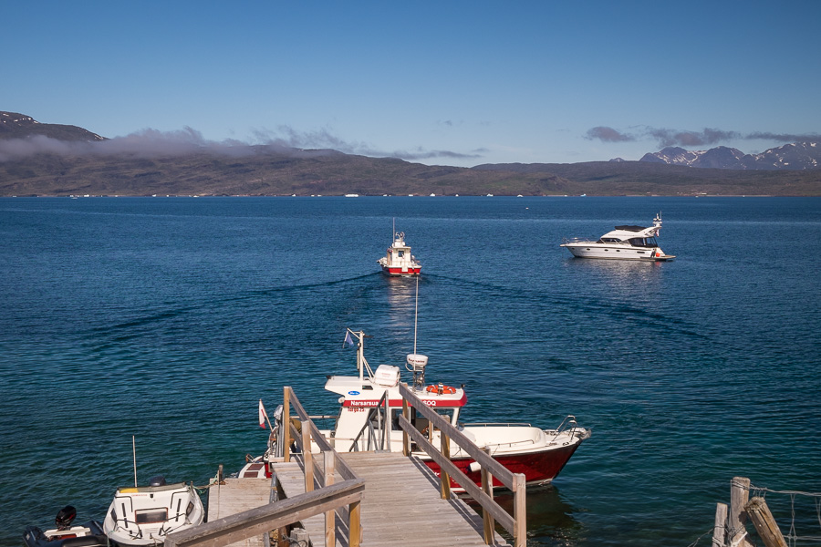 The dock at Itilleq which provides access to Igaliku. Two of the red and white Blue Ice transfer boats are visible as is a private yacht