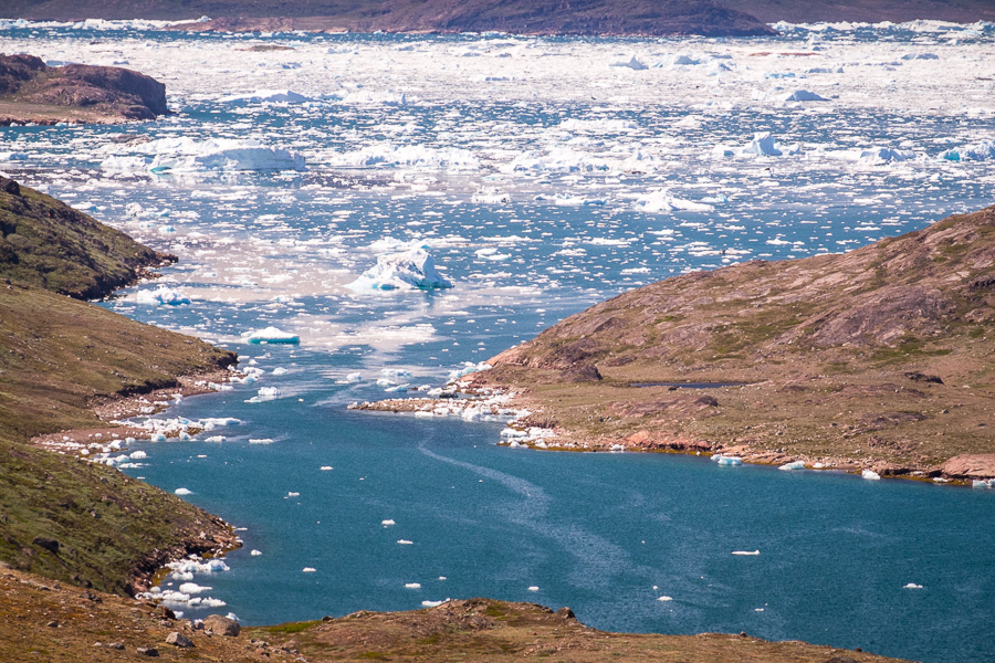 Small icebergs fill the fjord near Tasiusaq. View while hiking from Sillisit to Qassiarsuk via Nunataaq in South Greenland
