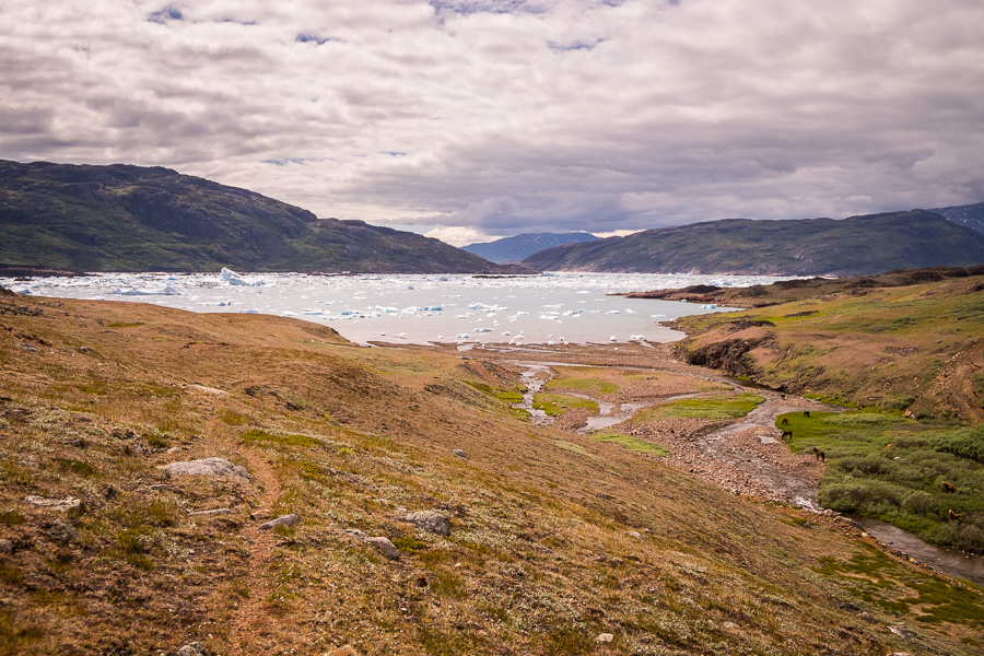 View of icebergs and the Southern Sermilik Fjord. Hiking towards Tasiusaq in South Greenland
