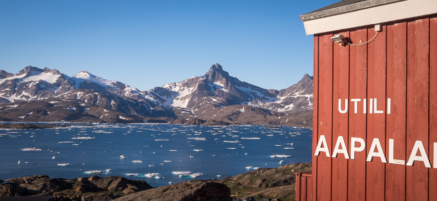 The edge of the Red House with its name in Greenlandic, overlooking the Tasiilaq Fjord - East Greenland