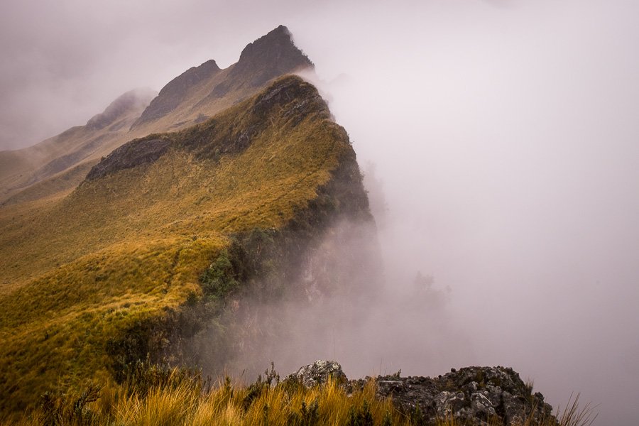 Crater ridge and crater filled with fog, while hiking to the summit of Volcán Pasochoa near Quito, Ecuador