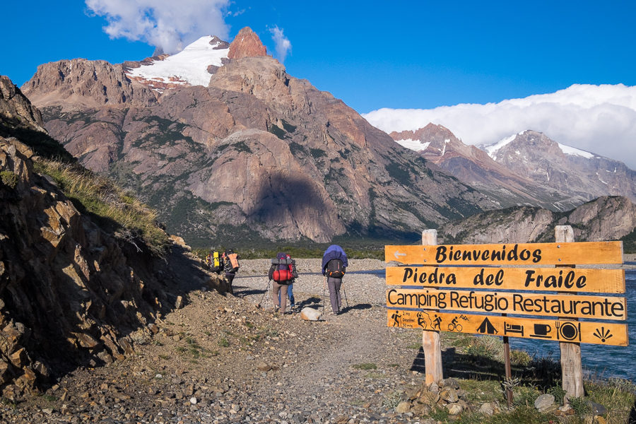 Trekking companions walking past sign to Piedra del Fraile - South Patagonia Icefield - Argentina