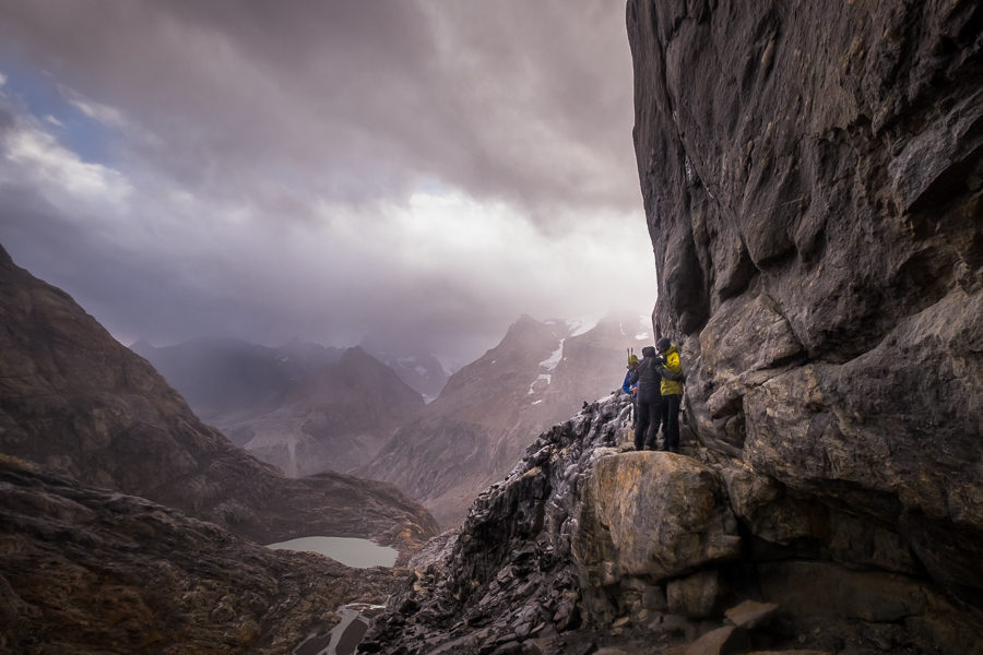 Juan helping Anita on top of a narrow ledge with a steep drop-off to the left - South Patagonia Icefield Expedition - Argentina