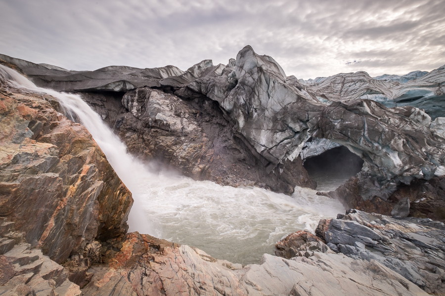 Waterfall and Ice cave at the base of the Russell Glacier near Kangerlussuaq, West Greenland