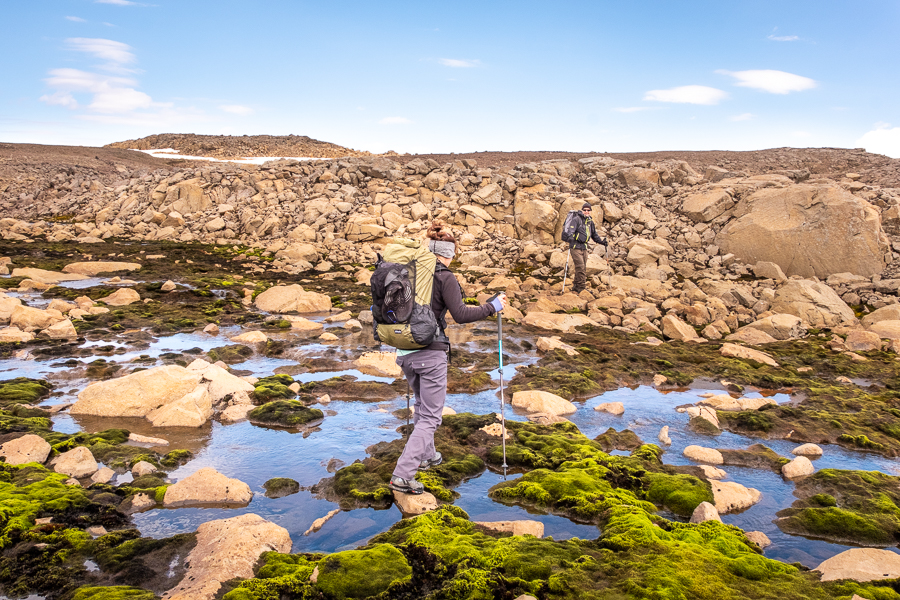 Rock hopping across another stream on Day 2 of Shadow of Vatnajökull trek - East Iceland