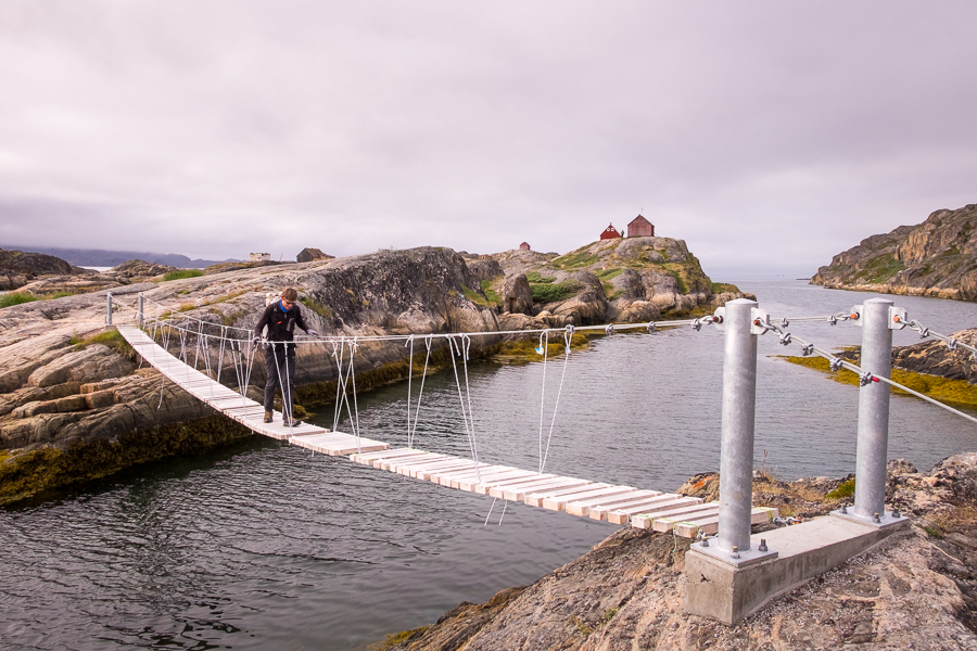 My friend making his way across the footbridge with Assaqutaq in the background, near Sisimiut, West Greenland