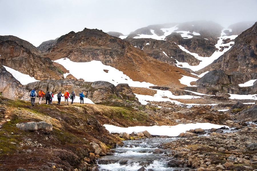 Hiking along a river at the start of the Sermilik Way - East Greenland