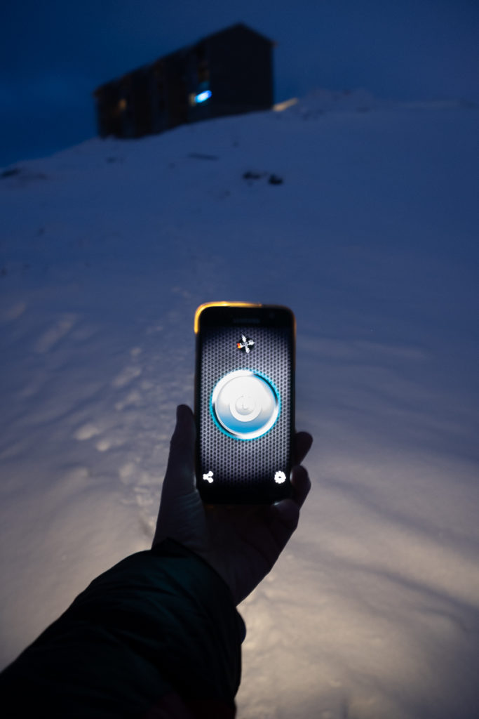 Image of phone with flashlight on and my apartment in the background - Nuuk - Greenland