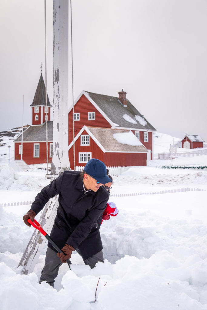 Miki shoveling snow around the flagpole - Nuuk Multi Kulti - West Greenland