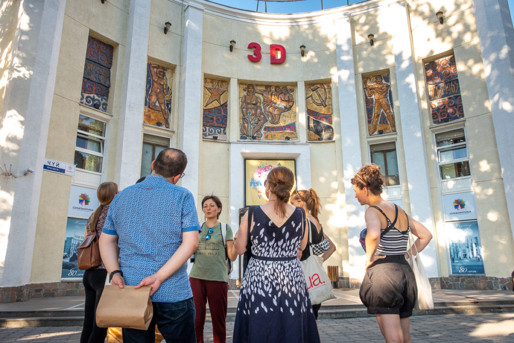 Walking tour group in front of Ala-Too movie theatre - Bishkek