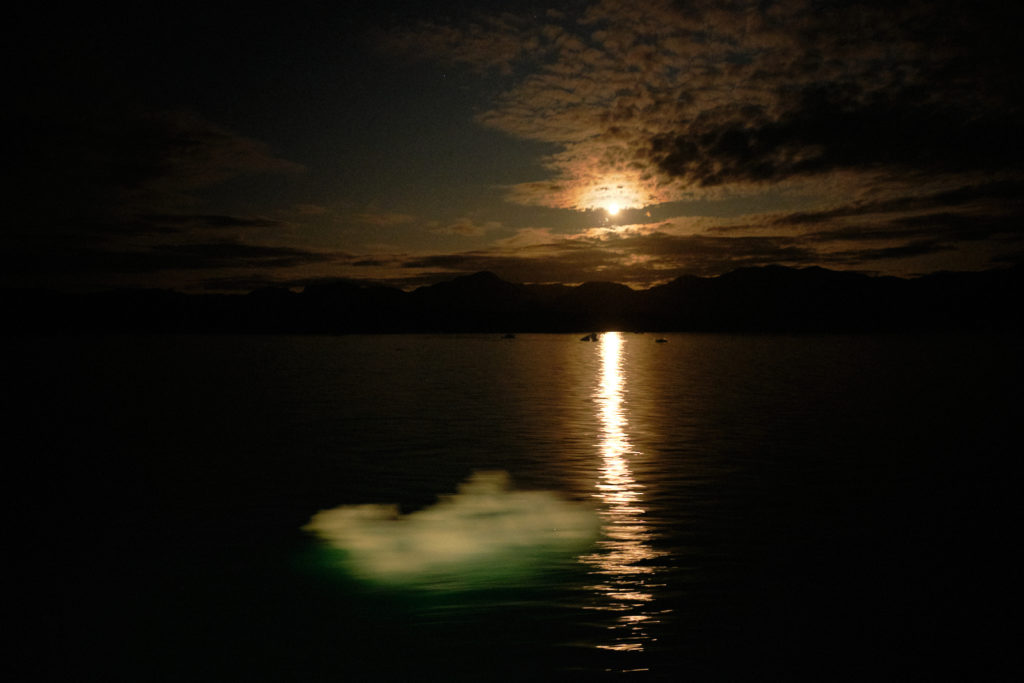 Passing small icebergs on the Sarfaq Ittuk ferry as the moon rises