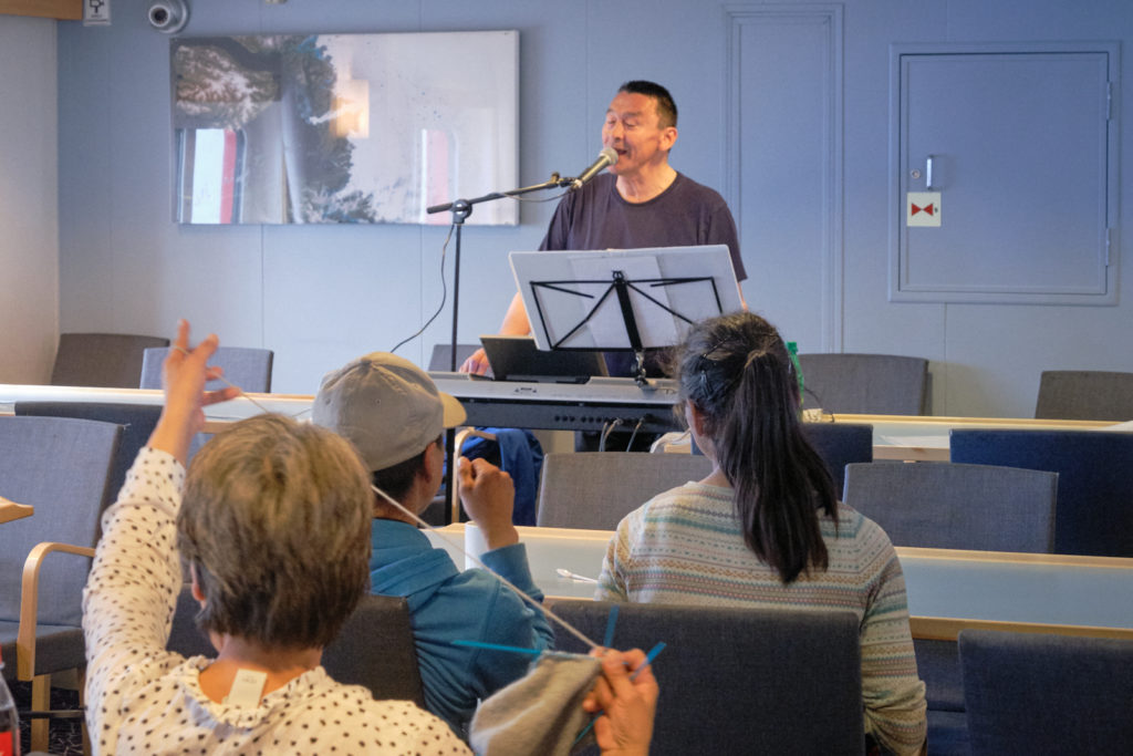 musician playing an impromptu concert in Cafe Sarfaq - Sarfaq Ittuk - West Greenland