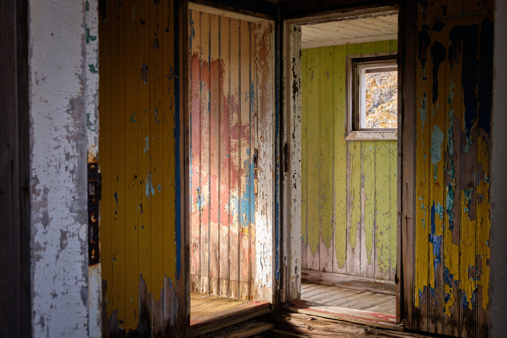 Peeling paint in colourful rooms at the abandoned settlement of Kangeq near Nuuk-Greenland