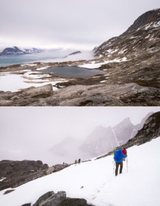 Trekking companions hiking through clouds, fog and rain