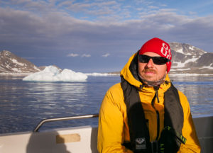 One of my trekking companions sitting on the boat back to Kulusuk in the weak sunshine