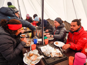 My trekking companions and I eating dinner in the cook/dining tent on the first day of Unplugged Wilderness