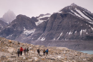 Trekking group hiking on scree en route to the Karale Glacier viewpoint