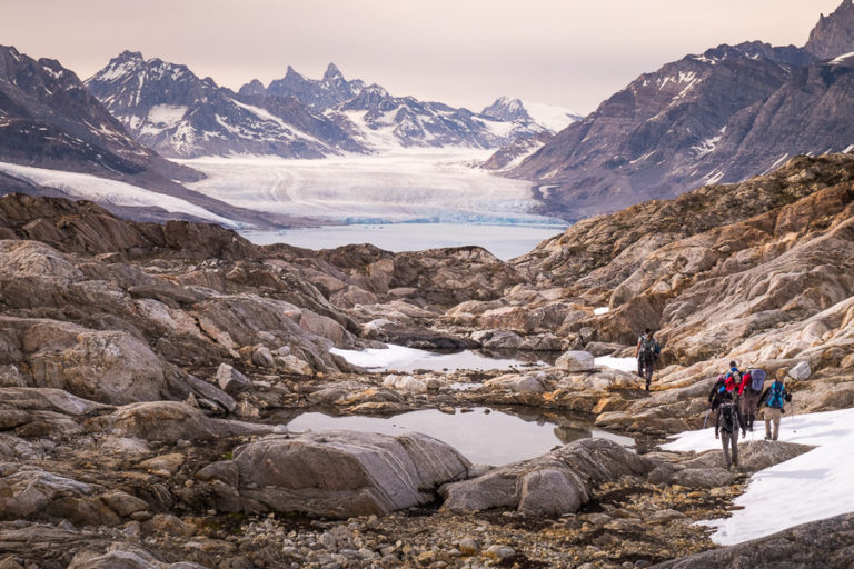 Trekking group passing more tarns with the Karale Glacier prominent in the background