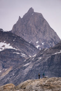 2 of my trekking companions looking very small in front of the mountains on the other side of the Karale fjord