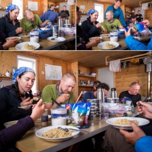 Our group sitting around the table in the Tasiilaq Mountain Hut eating dinner