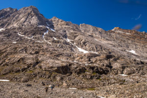 My trekking companions dwarfed by enormous granite cliffs while hiking in the Tunup Kua Valley