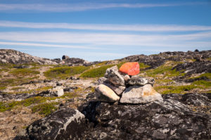 Red marks painted on rocks show the hiking routes around Igaliku in South Greenland