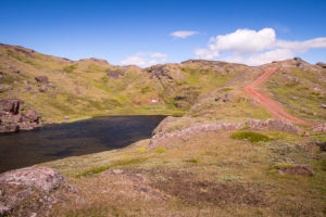 A red road leading up to the pass that separates Nunataaq from Qassiarsuk in South Greenland