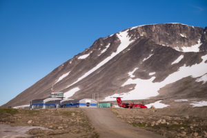 Looking along the road towards the Kulusuk airport terminal, with an Air Greenland plane parked.