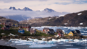 A view of Kulusuk, the second largest settlement in East Greenland, and icebergs in the fjord