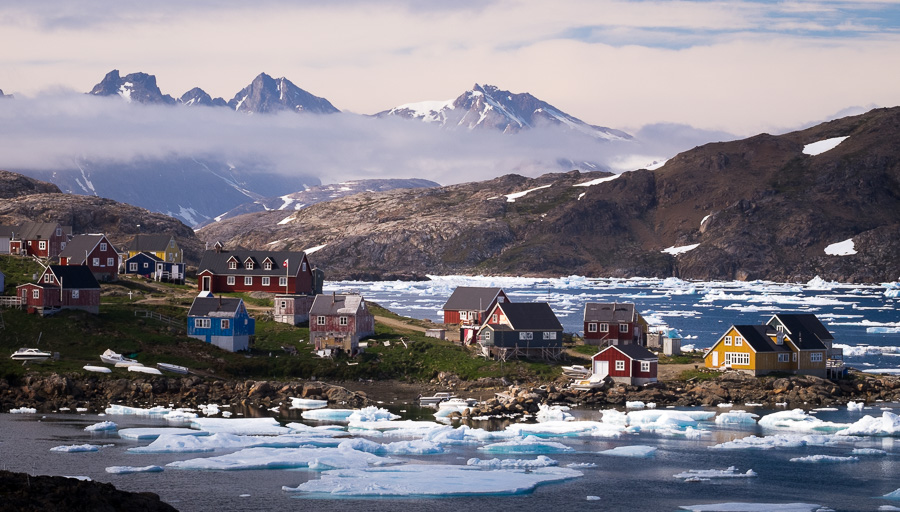 A view of Kulusuk, the second largest settlement in East Greenland, and icebergs in the fjord