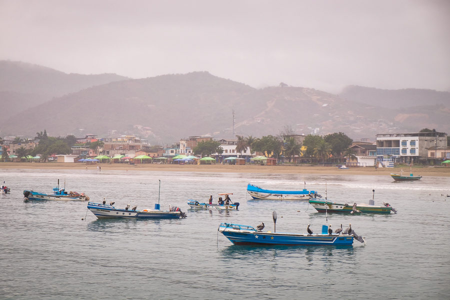 The beach and town of Puerto Lopez behind the fishing boats that sustain the community for most of the year