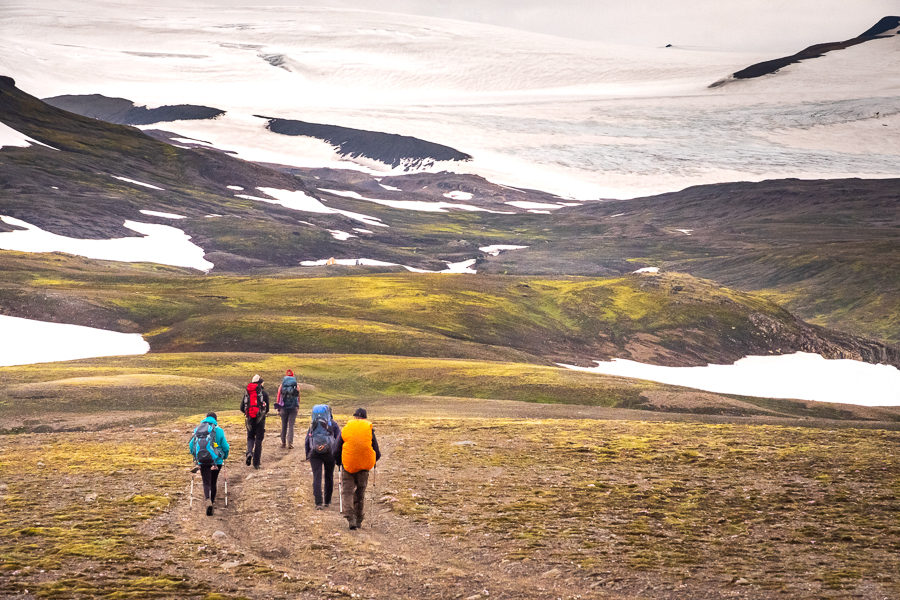 Hikers walking towards Geldingafell Hut - Shadow of Vatnajokull - East Iceland