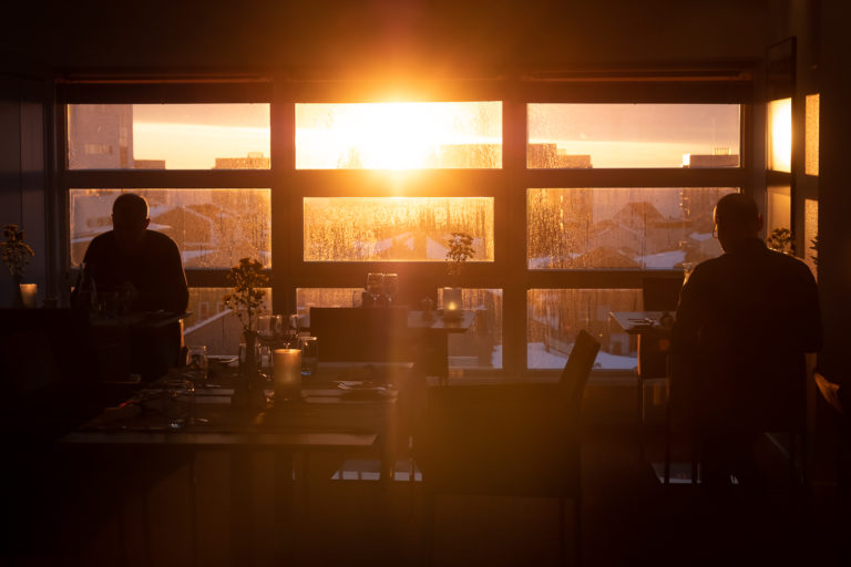 Golden sunset through Sarfalik Restaurant on top of the Hotel Hans Egede in Nuuk - West Greenland
