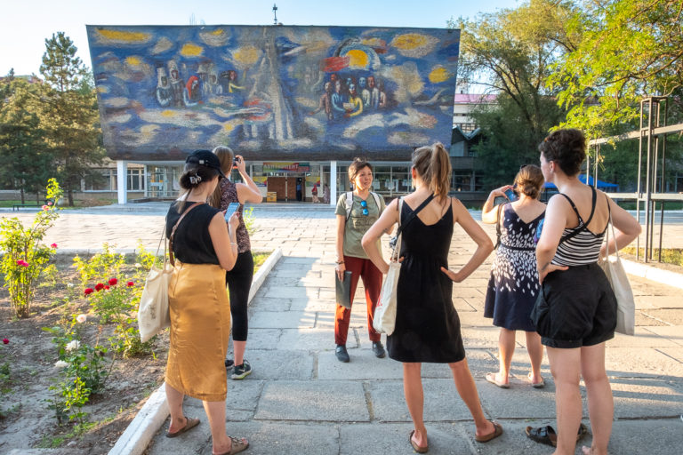 Walking tour group in front of the Path to Enlightenment mosaic - Bishkek