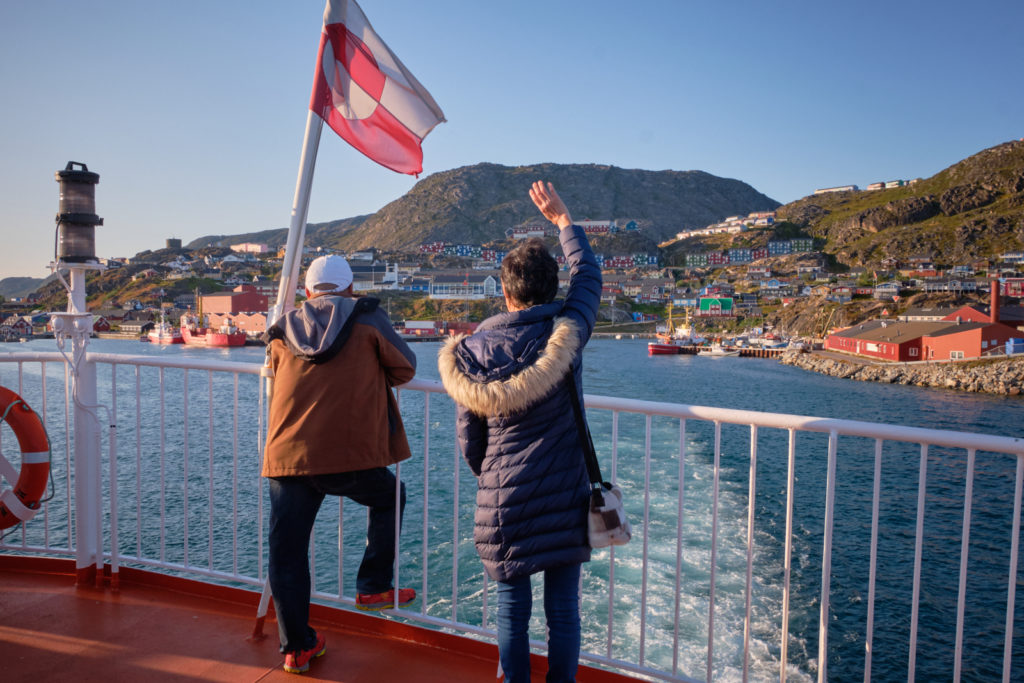 Locals waving goodbye to loved ones from the top deck of Sarfaq Ittuk as we leave Qaqortoq