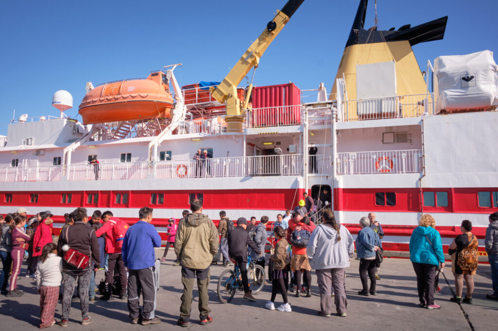 Passenger Ferry docked in Greenland with visitors disembarking at a harbour.
