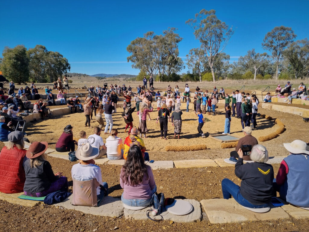 Audience participating with performers from the Gomeroi Dance Company in a traditional dance at the 2026 Myall Memorial Creek Commemoration Ceremony